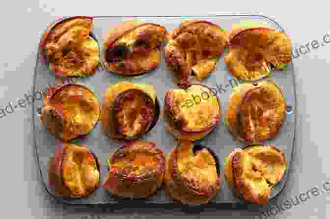 A Photograph Of Yorkshire Puddings Baking In A Muffin Tin, Showing Their Puffed Up, Golden Brown Exterior. Fried Ants And Yorkshire Pudding