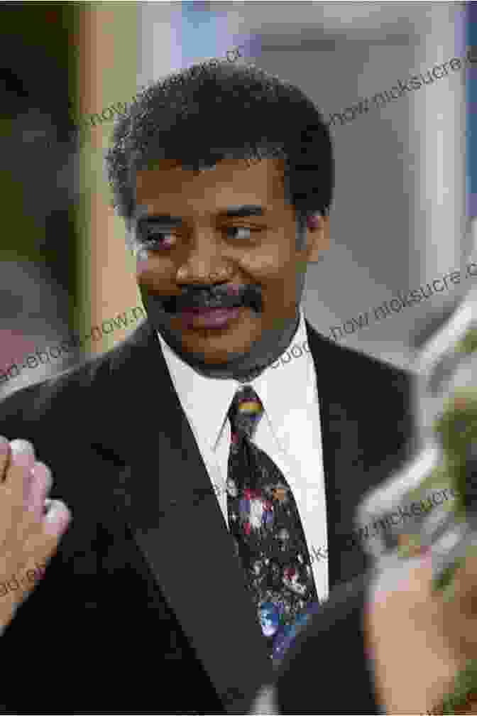 Neil DeGrasse Tyson, Wearing A Dark Suit And Tie, Smiling And Looking Directly At The Camera Our Better Angels: Stories Of Disability In Life Science And Literature